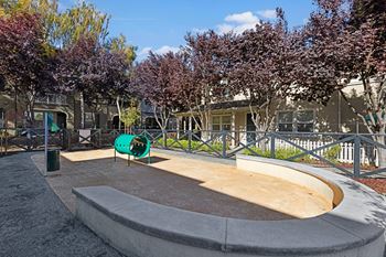 A playground with a slide and a green sign.