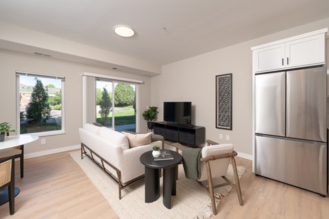 A modern living room with a white sofa and a black television.