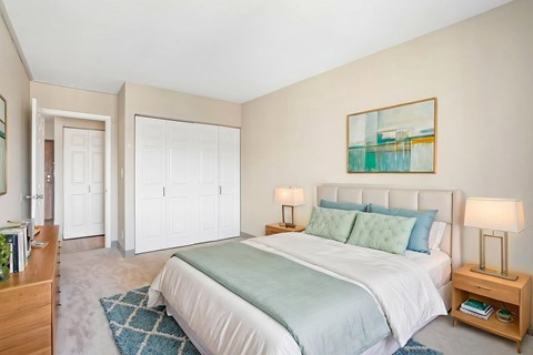 Virtually staged Irvine Park Towers bedroom with bed, nightstands and double closet doors