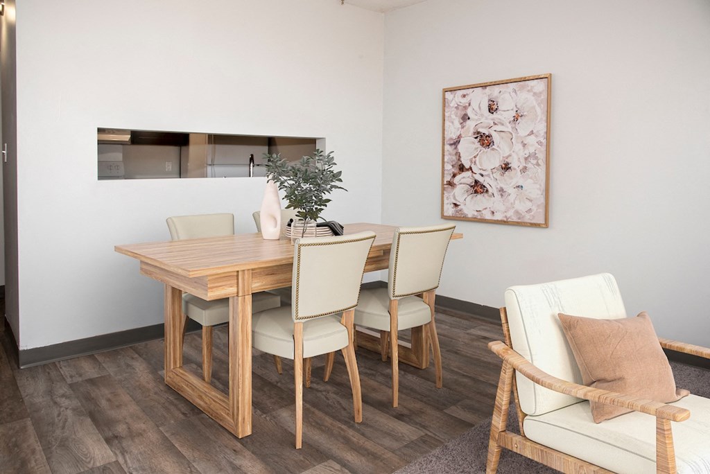 a dining room with a wooden table and chairs
