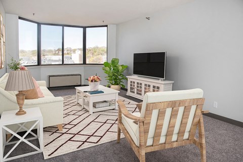 a living room with a couch and chairs and a television