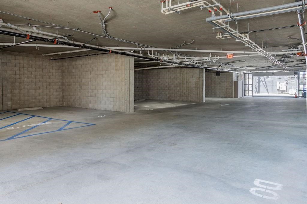 A large, empty parking garage with concrete floors and walls.