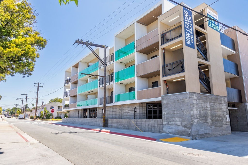 A multi-story building with a sign that reads "MODERN LEISURE" on the side.