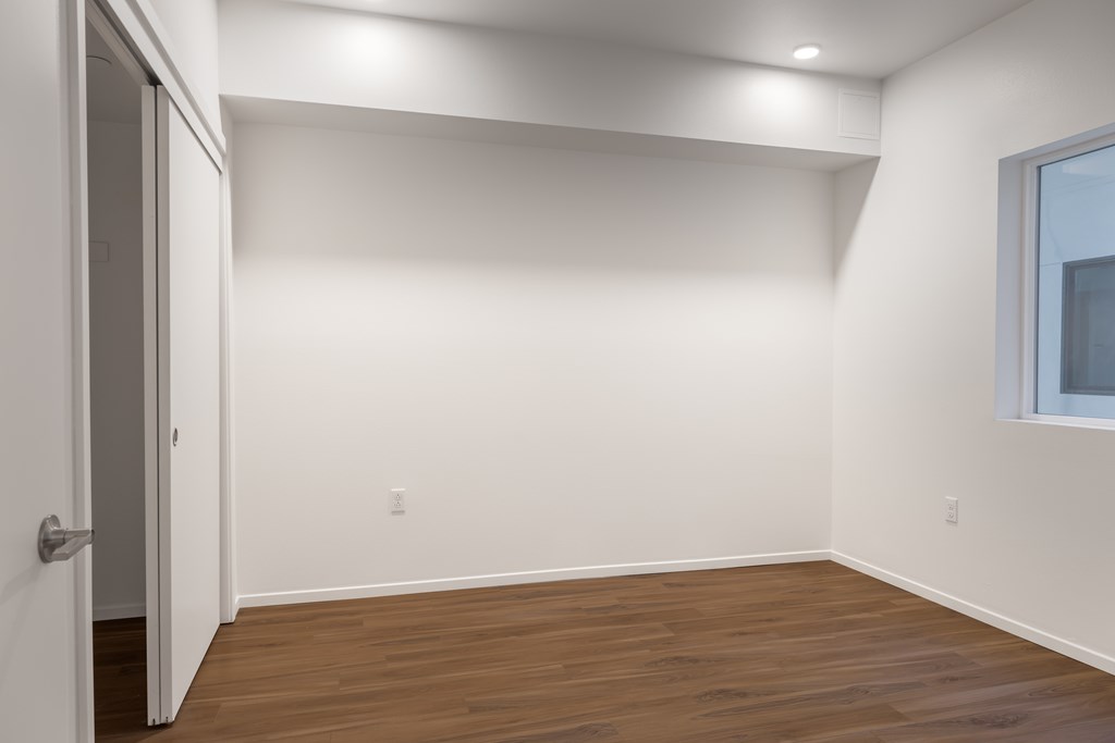 A room with a wooden floor and white walls.