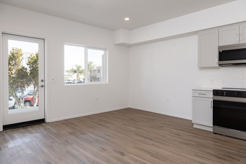 A kitchen with a white oven and microwave built into the cabinetry.