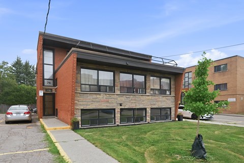A brick building with the number 76 on it.