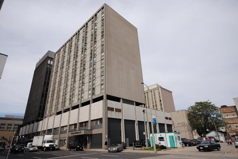 A large building with a flat roof and a grey facade.