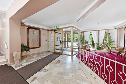 A hallway with a red and white patterned railing.