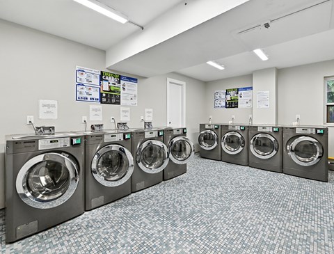 A laundromat with rows of washing machines.