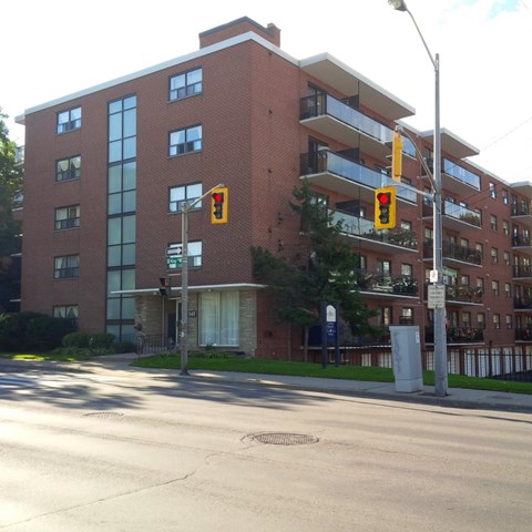 A red brick building with a balcony on the second floor.