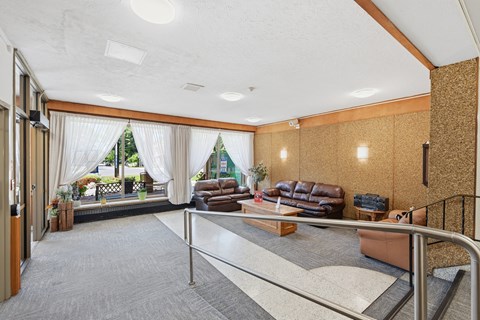 A living room with a couch, chairs, and a coffee table.