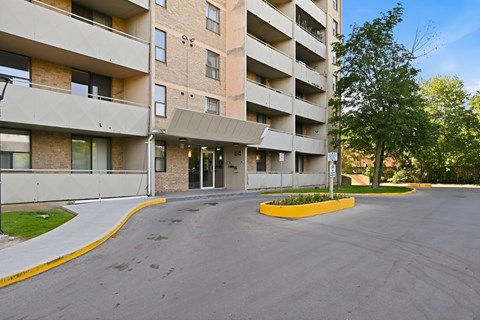A large building with a parking lot in front.