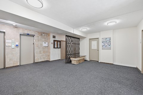 A room with a grey carpet and a white ceiling.
