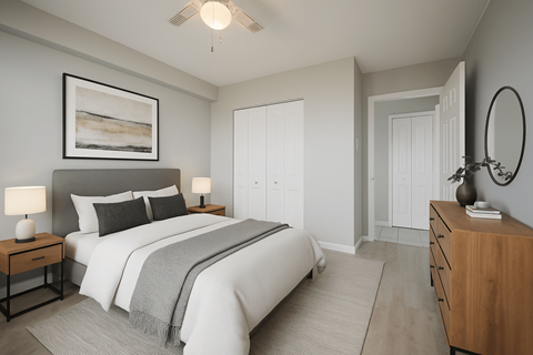 A bedroom with a large bed, a painting above it, and a wooden dresser.