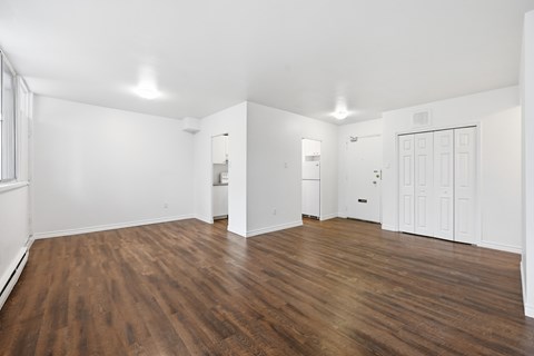 A room with wooden floors and white walls.