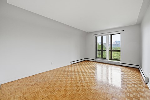 A room with a wooden floor and a sliding glass door.