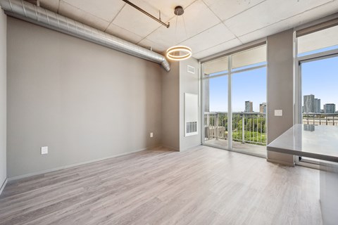 A room with a large window overlooking a cityscape.