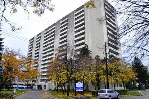 A tall building with a sign in front of it.