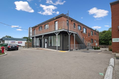 A building with a parking lot in front of it.