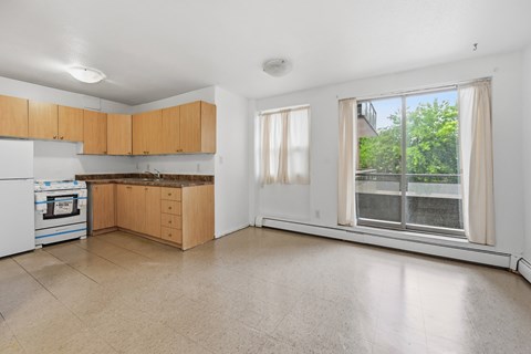 A kitchen with wooden cabinets and a white oven.