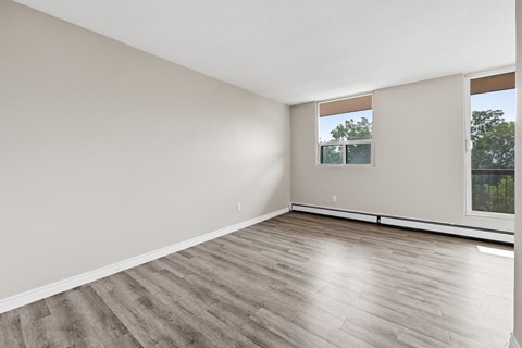 A room with wooden flooring and a window.