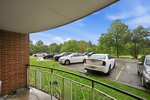 A parking lot with cars and trees in the background.