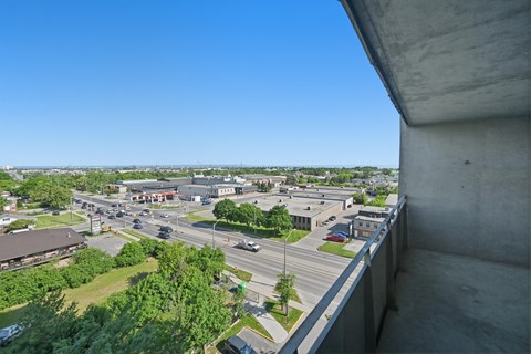 A view from a high vantage point looking down at a busy intersection with cars and buildings.