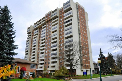 A large brick building with many windows and balconies.