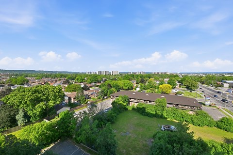 A view of a green field with a building in the background.