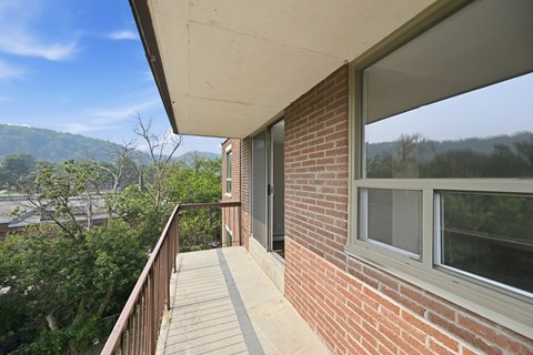 A balcony with a view of a mountain range.