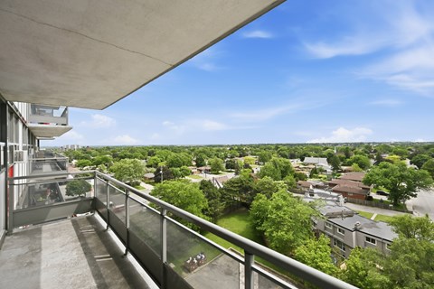 A balcony overlooks a residential area.