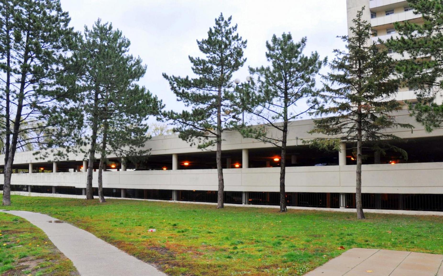 A building with a parking garage in front of it.