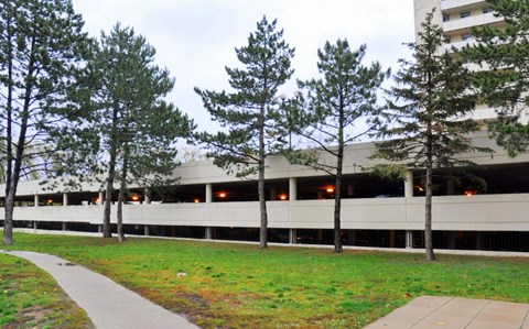 A building with a parking garage in front of it.
