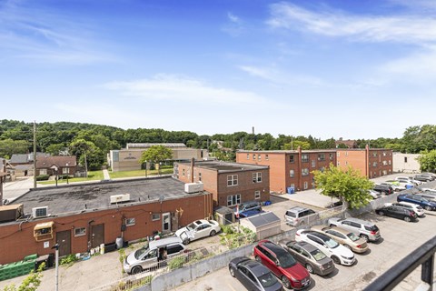 A parking lot with cars and a building in the background.