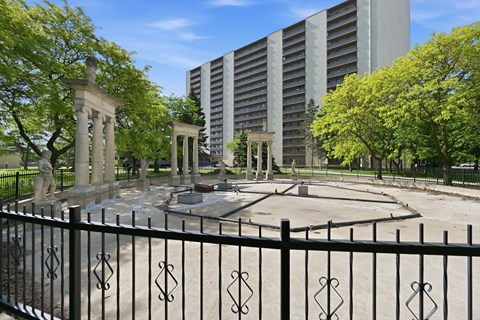 A black fence with a decorative design surrounds a circular courtyard.