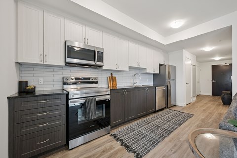 A modern kitchen with a black oven and microwave.