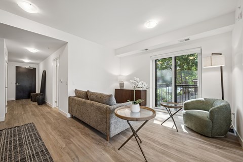 A living room with a couch, chair, and coffee table.