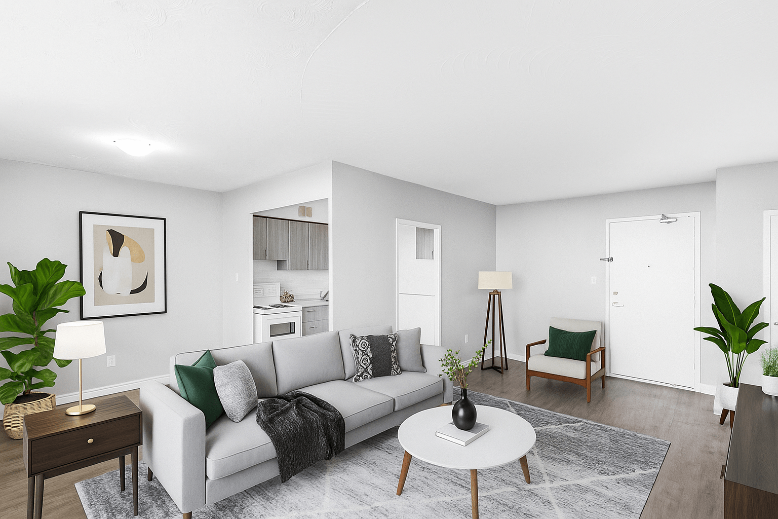 A living room with a grey couch, a coffee table, and a painting on the wall.