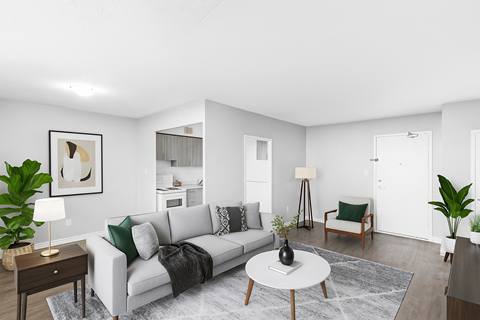 A living room with a grey couch, a coffee table, and a painting on the wall.