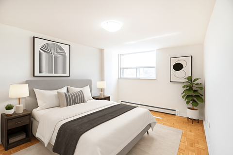 A bedroom with a large bed and a plant.