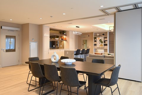 A modern dining room with a table set for four at Roxy Apartments, Hamilton, ON