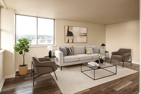 A living room with a grey sofa, a brown armchair, and a coffee table.