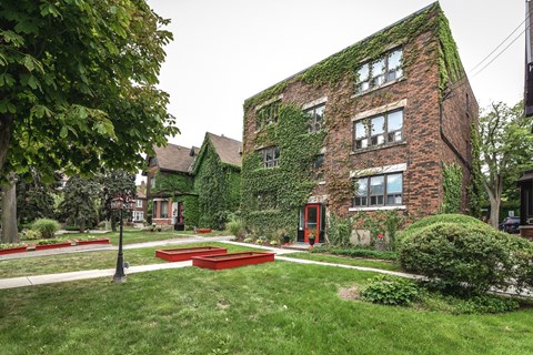 A red brick building with ivy growing on it.