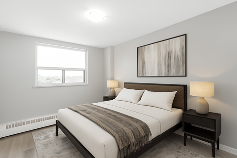 A bedroom with a large bed and a painting on the wall.