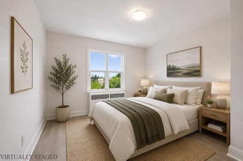 A bedroom with a large bed and a window.