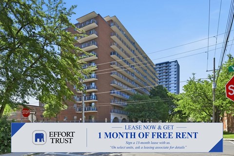 A large building with a sign in front that says "1 month of free rent".