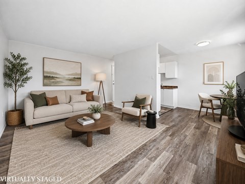 A living room with a couch, chairs, and a coffee table.