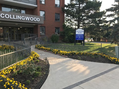Collingwood building with a sign in front of it.