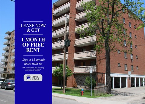 A tall building with a sign offering free rent for the first month.