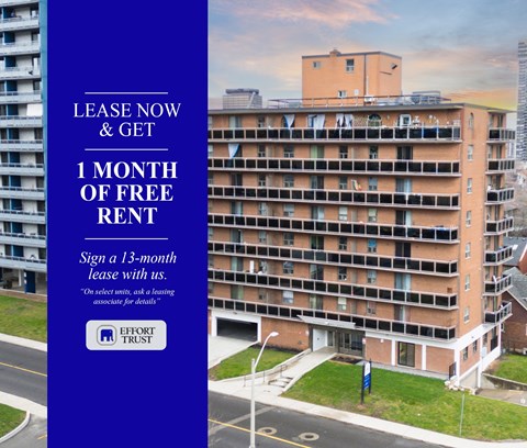 large building with a blue sign offering a free month of rent.